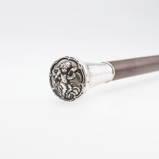 Wooden cane with silver handle with the representation of a cupid, 20th Century.