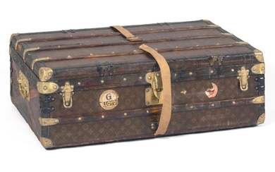 LOUIS VUITTON STEAMER TRUNK Exterior with allover LV monogram, beechwood slats, and brass locks, handles and hardware. Sides with re...