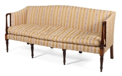 SHERATON SOFA In mahogany, with floral and gold striped upholstery. Four tapered reeded front legs and four block rear legs. Back he...