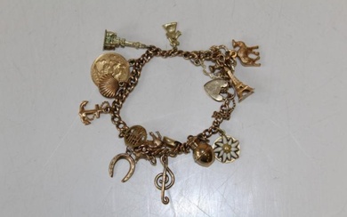 A 9ct gold charm bracelet with a heart padlock clasp....