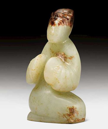 A CELADON AND RUSSET JADE CARVING OF A MUSICIAN.