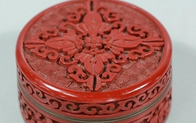A COPPER RED LACQUER CIRCULAR BOX CARVED FLORAL PATTERN
