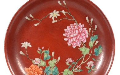 A CORAL-RED GROUND FAMILLE ROSE FLOWER PLATE