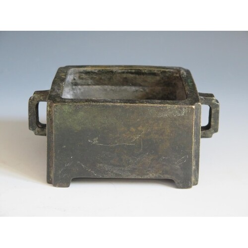A Chinese Bronze Censer with lug handles, four character mar...