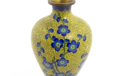 A Chinese cloisonne vase with a yellow ground decorated with blue prunus flowers / blossom. Approx.