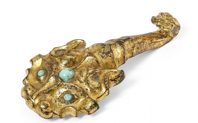 A Chinese gilt bronze belt hook, Han dynasty, finely cast...
