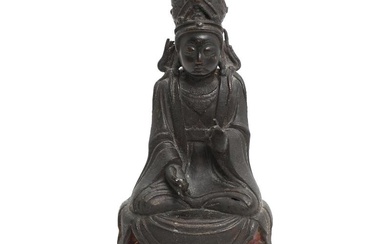 A Chinese patinated bronze figure of Guanyin, seated at lotus throne wearing flowing robes with floral borders and jewellery. Weight app. 2584 g. Ming 1344–1668. H. 27 cm.