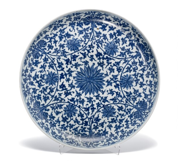 A Chinese porcelain dish decorated in underglaze blue with flowers and foliage in Kangxi manner. Late Qing, c. 1900. Diam. 47.5 cm.
