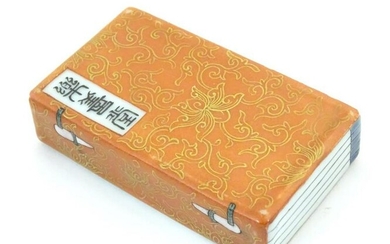 A Chinese porcelain model of a book with scrolling gilt