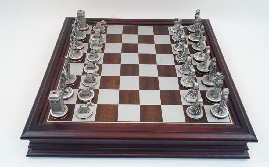 A Danbury Mint BBC licenced Doctor Who chess set, with 38 pewter chess pieces in original wooden box with chess board top, with booklet, 47.2cm x 47.2cm