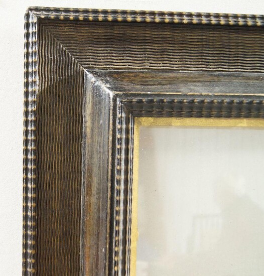 A Dutch Style Ebonised and Glazed Ripple Moulded Frame, late 20th century, with wedge sight, reverse ogee between twin ripple mouldings and combed frieze, added gilded slip, 50 x 60 cm (sight)