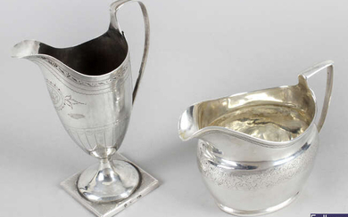 A George III silver cream jug & a helmet shape jug. (2).