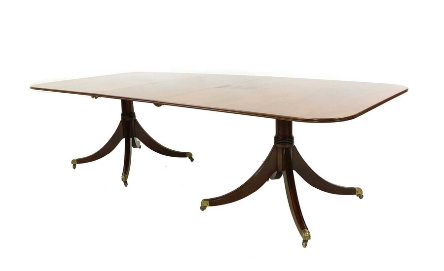 A George III style mahogany twin pillar dining table