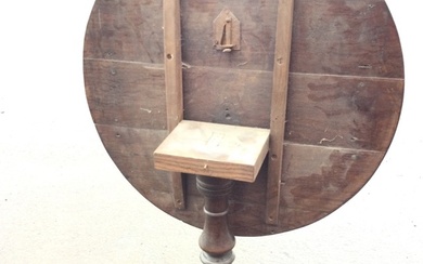 A Georgian oak tilt-top tea table with circular top on...