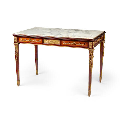 A Louis XVI style marble top gilt bronze mounted mahogany center table
