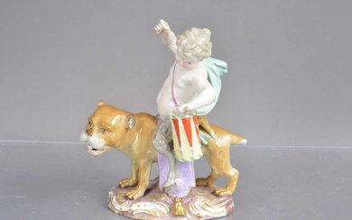 A Meissen porcelain figure group modelled as a young faun with drum riding a lioness.