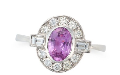 A PINK SAPPHIRE AND DIAMOND CLUSTER RING set with an oval cut pink in a border of round brilliant
