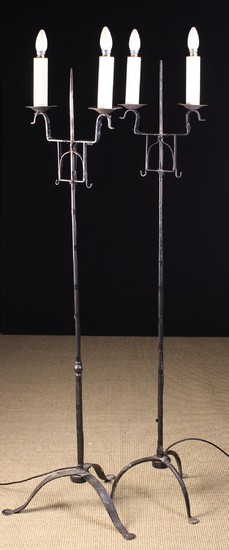 A Pair of Wrought Iron Twin-Branch Standard Lamps with electric 'candle' lights, fashioned as 18th c