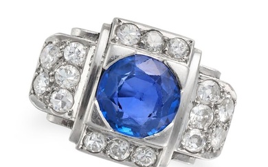 A RETRO SAPPHIRE AND DIAMOND RING in platinum, set with a round cut sapphire accented by single and