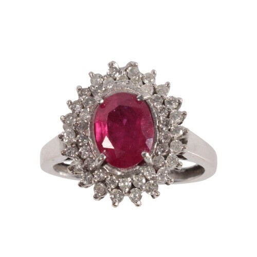 A SYNTHETIC RUBY AND DIAMOND CLUSTER RING the oval-cut ruby ...