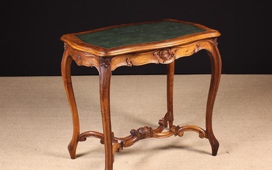A Small Late 19th Century Carved Walnut Writing Table in the Louis XV Style. The serpentine top with