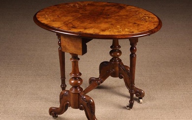 A Small Victorian Figured Walnut Sutherland Table inlaid with scrolling foliate embellishments and s