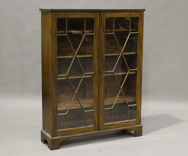 A Victorian figured mahogany bookcase, fitted with astragal glazed doors, on bracket feet, height 13