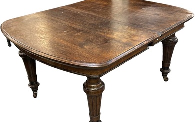 A Victorian oak extending wind-out dining table with additional leaf,...