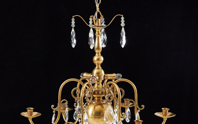 A baroque brass chandelier, with 6 light arms, 3 light points, different cut prisms, late half of the 20th century.