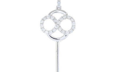 A brilliant-cut diamond key pendant.