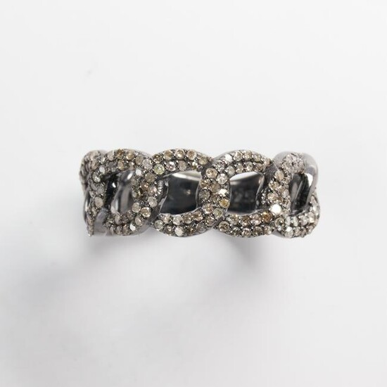 A diamond and sterling silver band ring