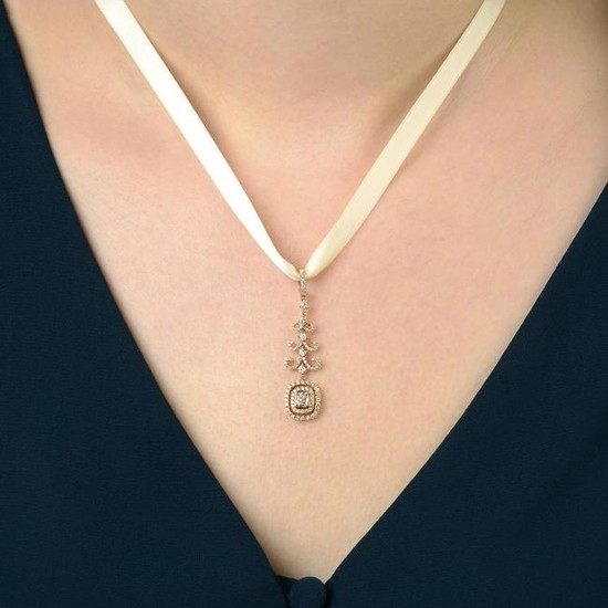 A diamond cluster pendant, with scrolling surmount.