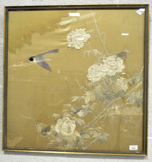 A large Asian silk embroidery, depicting birds amongst roses, sewn in satin stitch on a gold ground