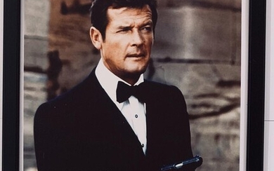 SOLD. A large signed colour still photograph of the English actor Sir Roger Moore in his role as James Bond. Photo size 35 x 28 cm. Framed. – Bruun Rasmussen Auctioneers of Fine Art