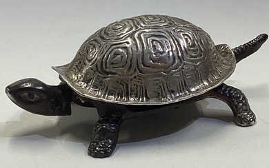 A large silver bell in the form of a tortoise.