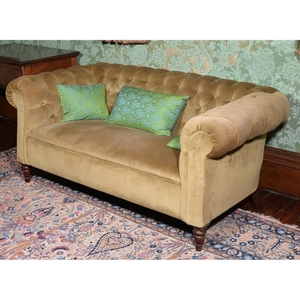 A mahogany and button upholstered sofa