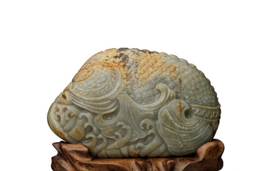 A massive green and russet jade carving of dragon fish