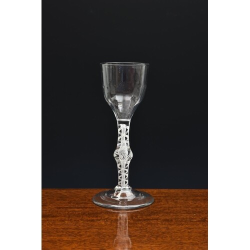 A mid-18th century opaque airtwist wine glass, c.1755, the h...