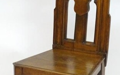 A mid 19thC oak Gothic hall chair with a pointed back