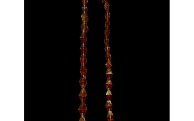 A mid-20th century graduated amber-like bead necklace The b...
