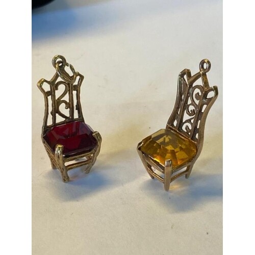 A pair of 9ct gold chair charms, one with a garnet Cushion a...