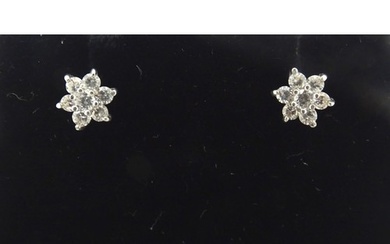 A pair of 9ct gold stud earrings set with diamond clusters. ...