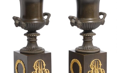 A pair of French Empire patinated bronze vases with gilt bronze mounting....