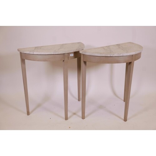 A pair of antique demilune console tables with later painted...