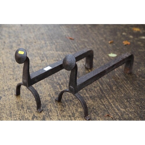 A pair of antique wrought iron fire dogs of 16th century des...