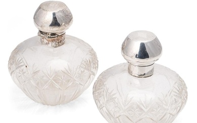 A pair of matching silver topped cut glass perfume bottles, ...