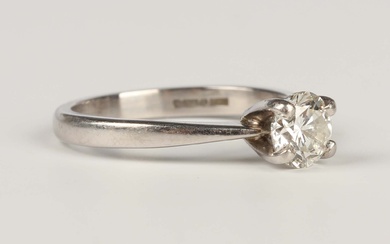A platinum and diamond single stone ring, claw set with a circular cut diamond, weight 3.5g, diamond