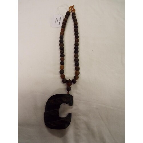 A pre 1947 Rhino horn beaded necklace with pendant weighing ...