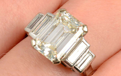 A rectangular-shape diamond single-stone ring, with baguette-cut diamond shoulders.