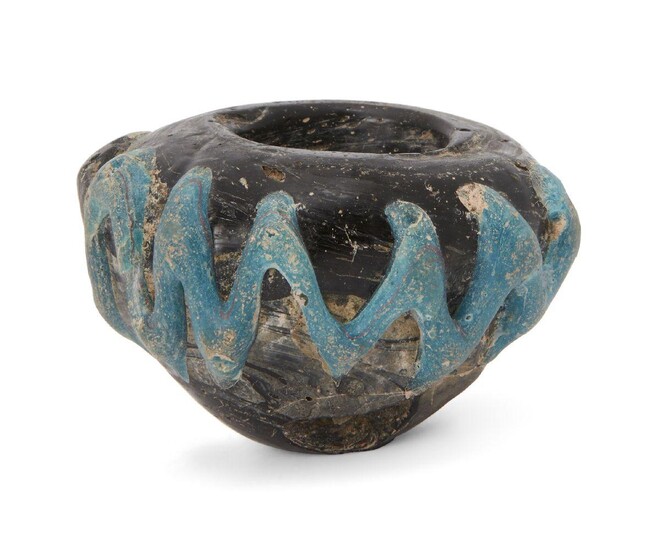 A rod-formed purple glass bulbous jar, Eastern Empire, 4th-5th century, with opaque turquoise thread zigzag trail motif to body, large chip to one side, 3cm. high. Provenance: Private collection London since 1968 For comparison see E. Stern, Roman...